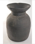 Brown metal antique Indian milk storage container with horizontal ridges and wide rim, on plain white background.