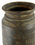 Close-up of a brown antique Indian metal milk storage container with wide rim and visible vertical crack.