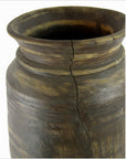 Close-up of a brown antique Indian metal milk storage container with wide rim and visible vertical crack.