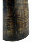 Close-up of a brown antique Indian milk storage container, cylindrical with carved horizontal and vertical lines.