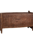 Brown wooden planter with weathered, chiseled texture and four legs, rectangular shape, rustic style.