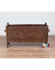 Brown weathered wooden planter on a wooden floor with a color chart in front.