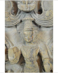 Brown sheesham wood carving of Shiva holding a book, ornate headdress and jewelry, detailed Indian design.