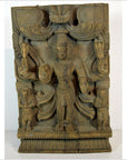 Brown sheesham wood Shiva statue with two smaller figures, Indian antique carving, close-up view.