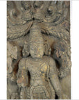 Brown Sheesham wood carving of a deity with ornate headdress, Tamil Nadu style, holding objects, close-up.