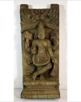 Brown Sheesham wood carving of Indian deity with intricate patterns and foliage detailing, close-up view.
