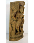 Brown Sheesham wood carving of a standing female with ornate headdress and detailed side patterns, front view.