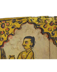 Close-up of antique Indian wood shrine with mustached man under arch, yellow and red floral accents, New Delhi origin.
