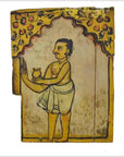 Brown wood Indian shrine with hand-painted doors, yellow arch, and a man in traditional attire holding a pot.