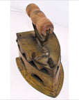 Brown wooden-handled antique Indonesian coal iron on white background, close-up view.
