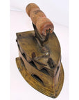 Brown wooden-handled antique Indonesian coal iron on white background, close-up view.