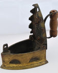 Brown wooden-handled metal coal iron with open lid and serrated edge on neutral surface.
