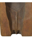 Close-up of brown wooden antique Indonesian hand-carved mold with smooth curved groove on rectangular base.