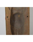 Brown wooden Indonesian mold, hand carved with torso, rounded belly, and small navel hole, close-up on neutral background.