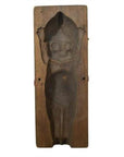 Brown wooden hand-carved Indonesian mold, doll design with raised arms and detailed face, close-up view.