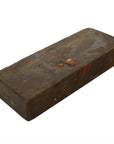 Brown brick with worn edges, made using antique Indonesian hand-carved wooden mold, close-up.