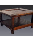 Brown wooden Indonesian coffee table with lower shelf, Dutch Colonial style, on plain background.