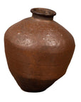 Brown ceramic Japanese oil jar with weathered finish and irregular shape, displayed on a white background.