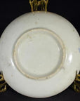 White porcelain Japanese Igezara transferware plate on decorative gold stand.