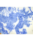 Blue porcelain Igezara transferware plate with floral and geometric patterns, delicate branch motifs, close-up.