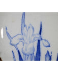 Blue and white porcelain Igezara plate with iris design, antique Japanese transferware, close-up view.