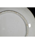 Close-up of the underside of an antique Japanese Igezara ceramic plate showing a square embossed maker’s mark near center.