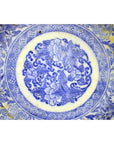 Blue and white ceramic Igezara transferware plate with circular floral and leaf pattern, close-up view.