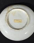 Close-up of the underside of an antique white ceramic Japanese Igezara transferware plate with “No. 5655/X JAPAN” label.