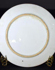 White porcelain Japanese Igezara transferware plate, minimalist back design, displayed on gold stand.