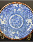Blue and white porcelain Igezara plate with reddish-brown rim, on stand.
