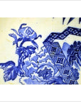 Close-up of blue and white porcelain Japanese Igezara plate with floral and geometric patterns.