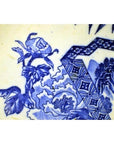 Close-up of blue and white porcelain Japanese Igezara plate with floral and geometric patterns.