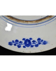 Blue and brown porcelain plate with vine pattern by rim and central ring, antique Japanese transferware.