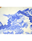 Blue and white porcelain Igezara plate with intricate floral and geometric edge patterns, close-up.
