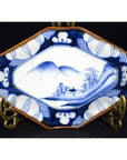 Blue and white porcelain Imari bowl with hand painted landscape, mountains, trees, and decorative border.