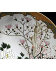 Close-up of antique Japanese Kutani porcelain bowl with hand painted pink blossoms and floral accents.