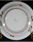 Antique hand painted Japanese Kutani porcelain plate on decorative metal stand.