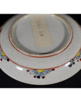 Close-up of the bottom of an antique Japanese Satsuma porcelain plate with a rectangular center label.