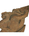 Brown wood Burmese temple carving, mirrored guardian relief with stylized headgear, isolated on white background.
