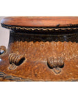 Close-up of brown ceramic Antique Martaban water jar neck and rim with decorative loops and organic details.