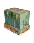 Close-up of a small, weathered green and brown antique miniature Chinese treasure chest on matching base.