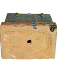 Close-up of a brown clay miniature Chinese treasure chest with a weathered finish, metal plate top, and two round bolt accents.