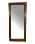 Close-up of antique mirror with rectangular wooden frame and metal latch on one side.
