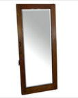 Antique mirror with angled reflection in sunlight, visible upright, showing detailed frame and glass surface.