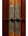 Close-up of ornate vintage metal door handles on 19th-century Chinese Ningbo elm and cypress wood cabinet.