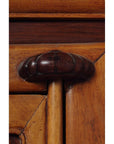 Close-up of carved wooden handle on antique brown elm and cypress cabinet, 19th-century Ningbo, China.