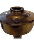 Brass oil lamp with round fuel chamber and threaded top, antique style, close-up view.