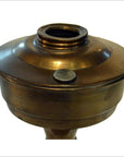 Close-up of antique brass oil lamp burner with screw cap and threaded opening, isolated on white background.