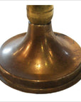 Close-up of antique brass oil lamp base with wide, rounded bottom, showing vintage brass finish.