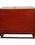 Close-up of an antique red lacquer wood bedside cabinet with metal hardware on a matching wood stand, mid-19th century China.